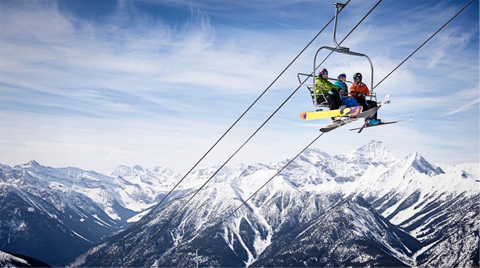 Group of skiers on chairlift above vertical at Panorama