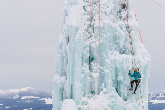 Man climbs the ice climbing tower at Big White