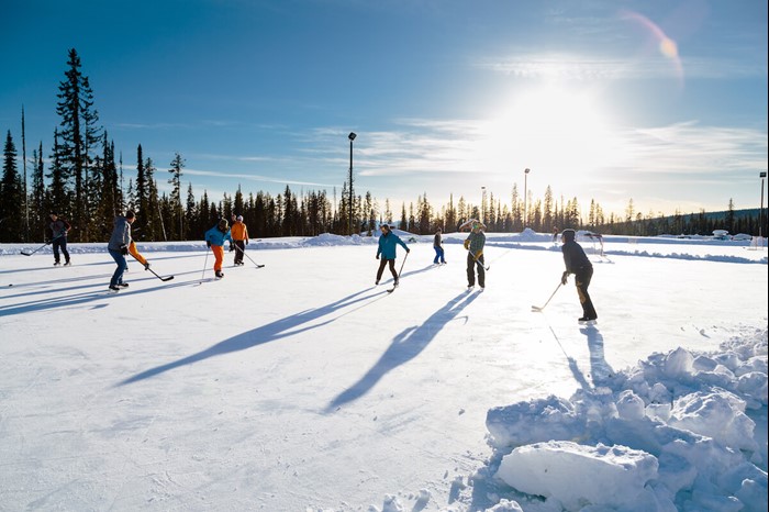 People playing hockey at the outdoor rink at Big White