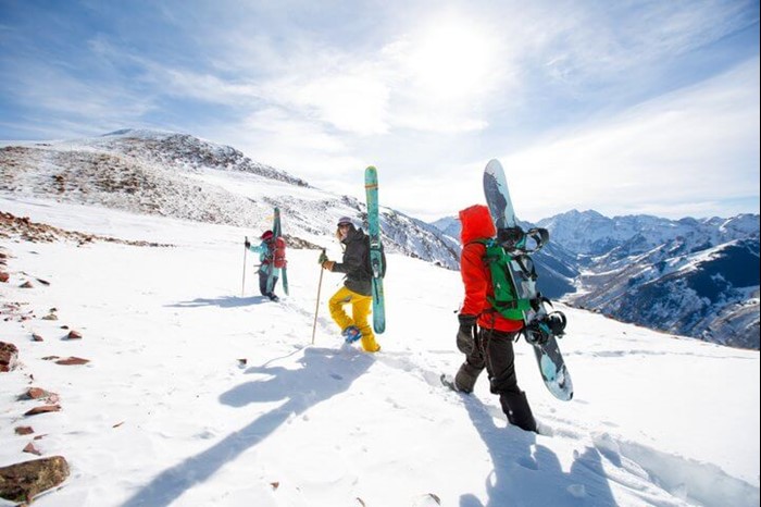 Group of skiers hiking to the summit of Highland Bowl