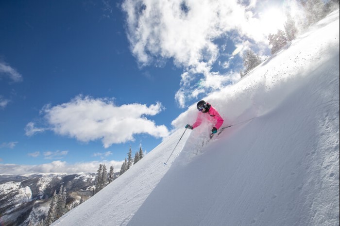 Skier deep in fresh powder at Highland Bowl