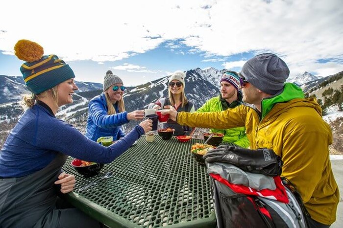 Group of skiers enjoying a drink at the Cloud 9 Alpine Bistro at Aspen Highlands