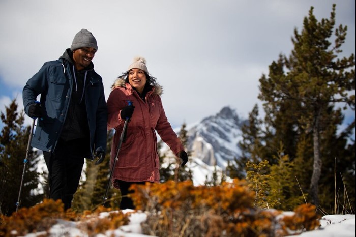 Man and woman hiking in Banff National Park in spring