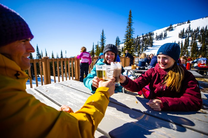 Group drinking beers mid-mountain at Sun Peaks