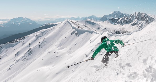 Person skiing at the top of the mountain