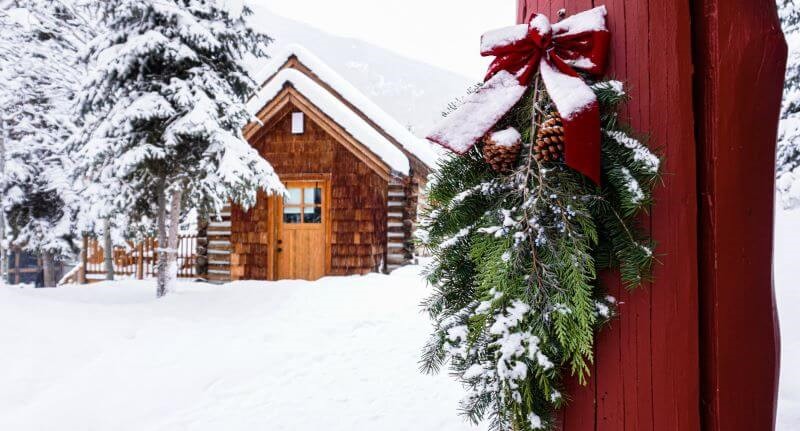 A photo of a holiday wreath on the door of a cabin in the village at Panorama Mountain Resort.