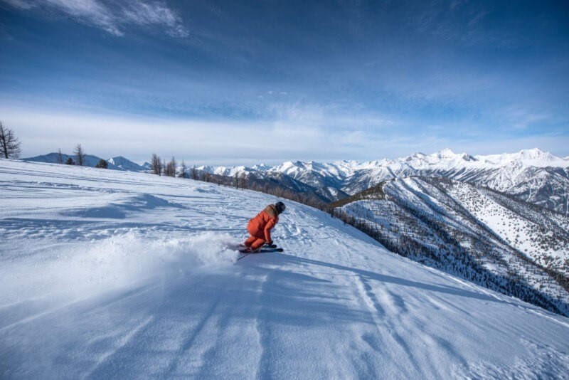 A person skiing down a snowy mountain at Panorama.