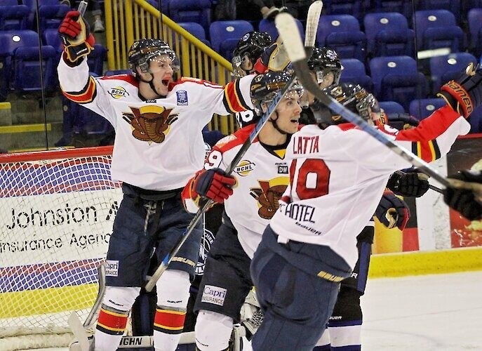 Vernon Vipers hockey team members cheering on the ice after scoring a goal