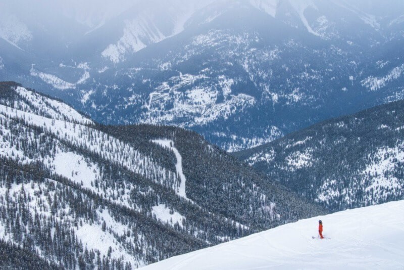 A photo of a single person in ski gear on a mountain at Panorama.