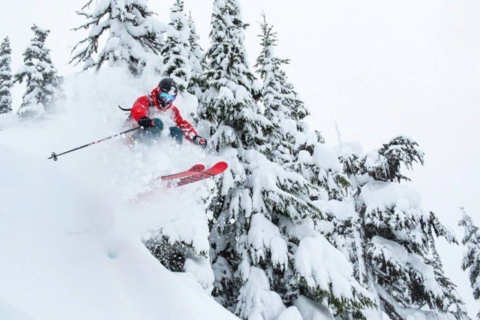 Skier flying through the fresh powder