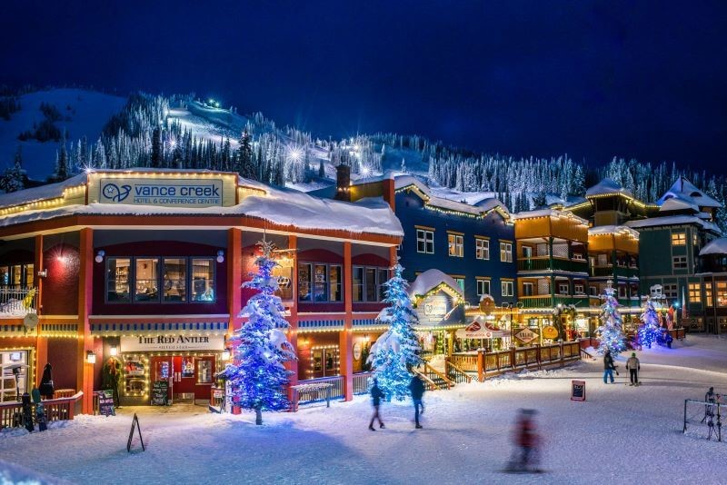 A photo of the Silver Star village illuminated with Christmas lights at night.